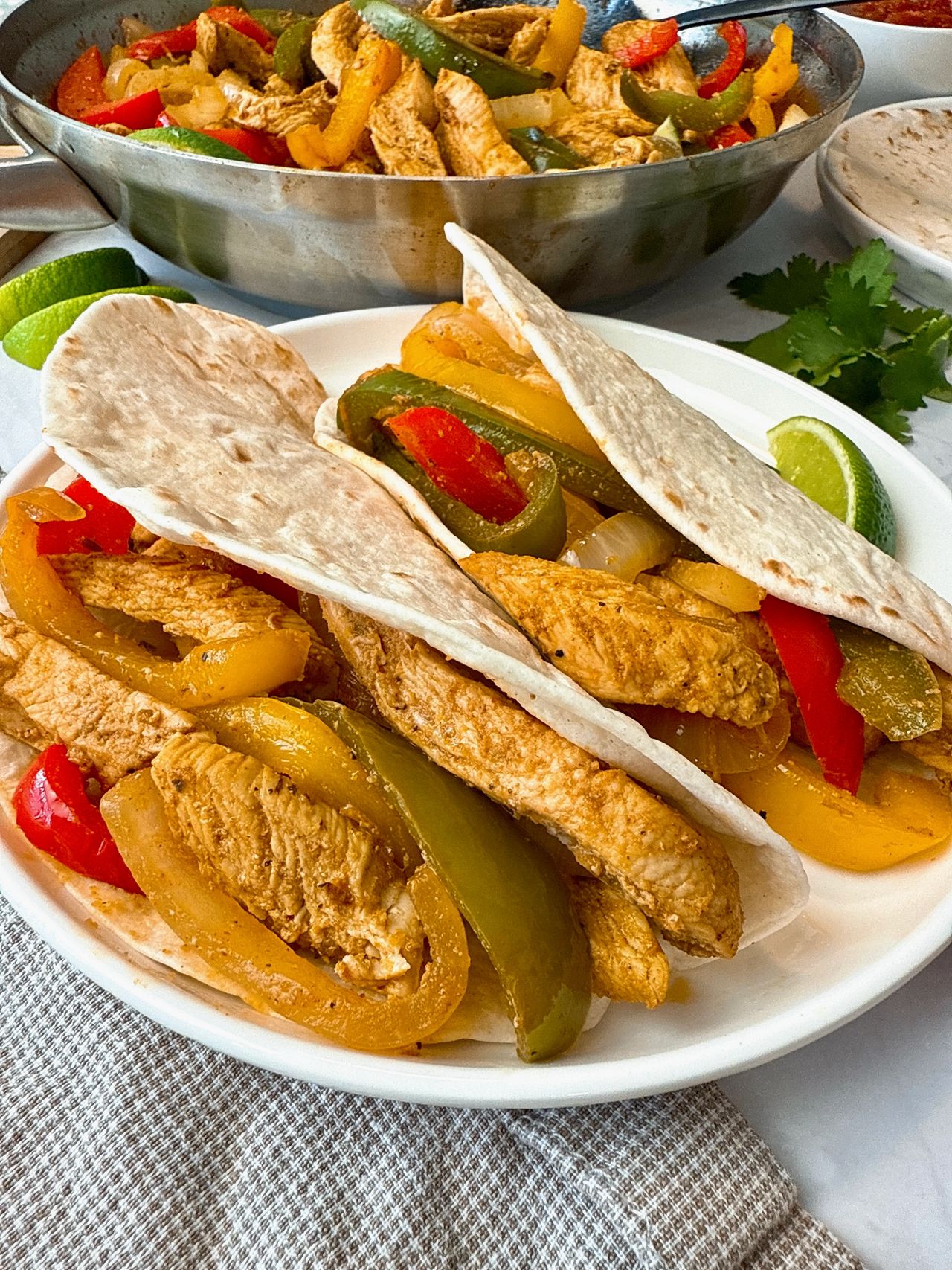 chicken and bell peppers in tortillas to make fajitas