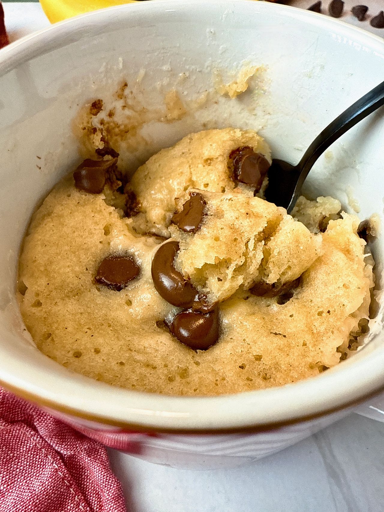 chocolate chip banana bread mug cake with a spoon