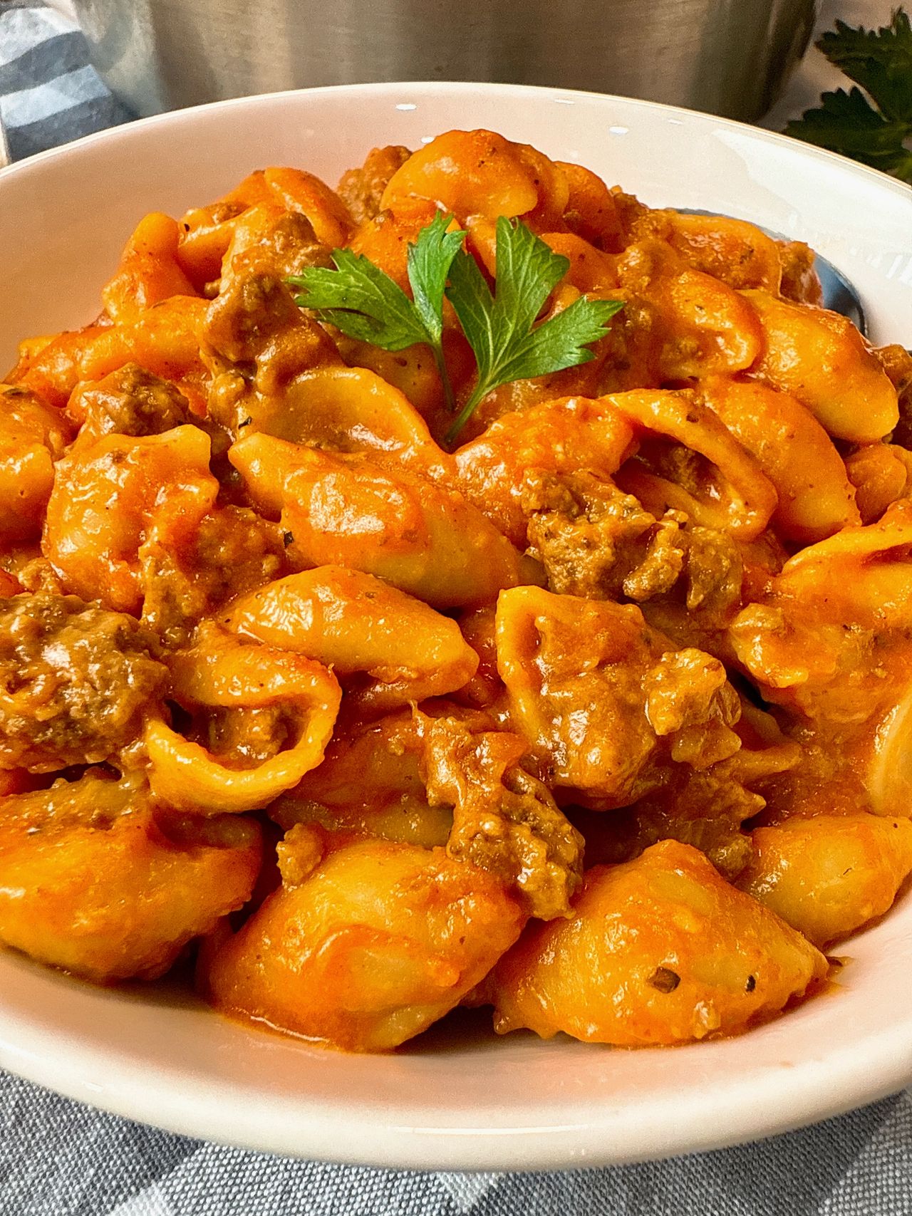 bowl of pasta and beef with a spoon