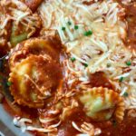 spinach ravioli and marinara sauce with mozzarella cheese