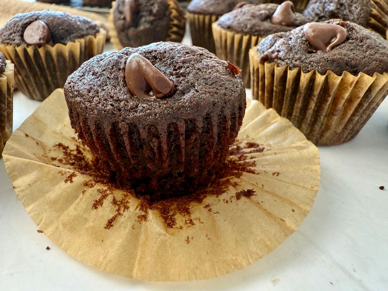 mini chocolate banana muffins on a white surface