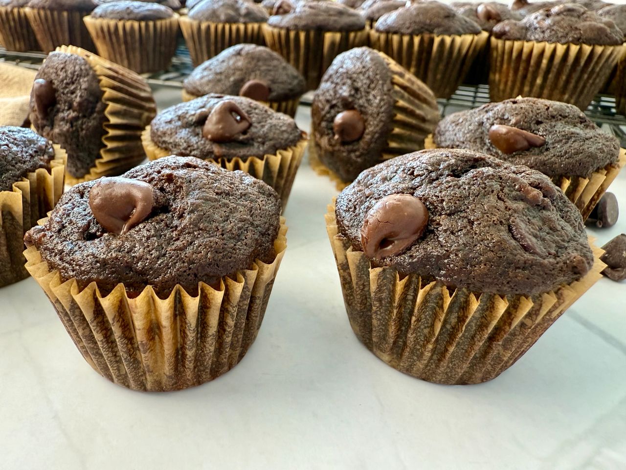 mini chocolate banana muffins on a white surface