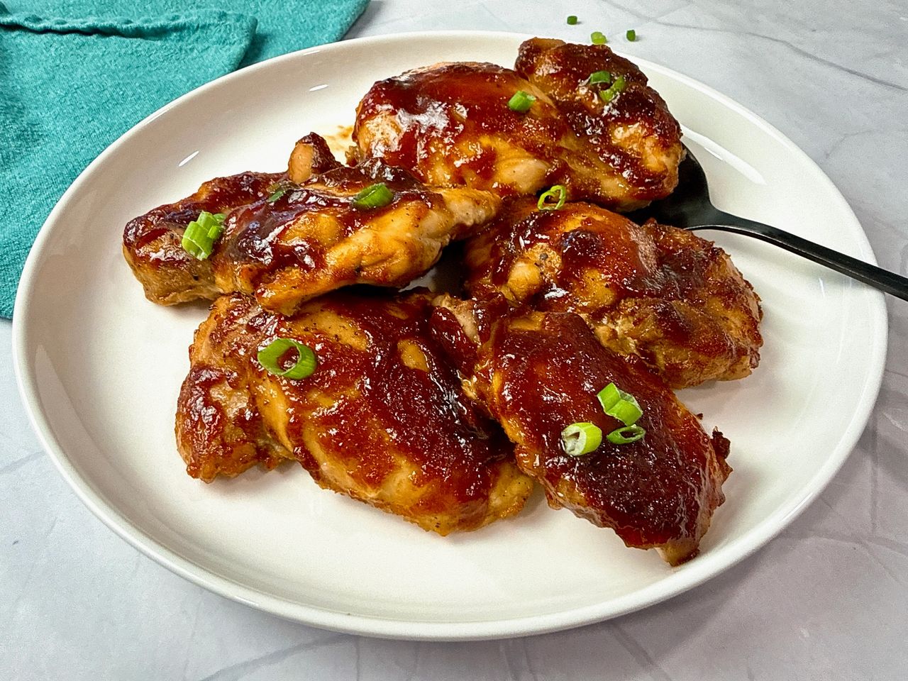 chicken thighs on a white plate