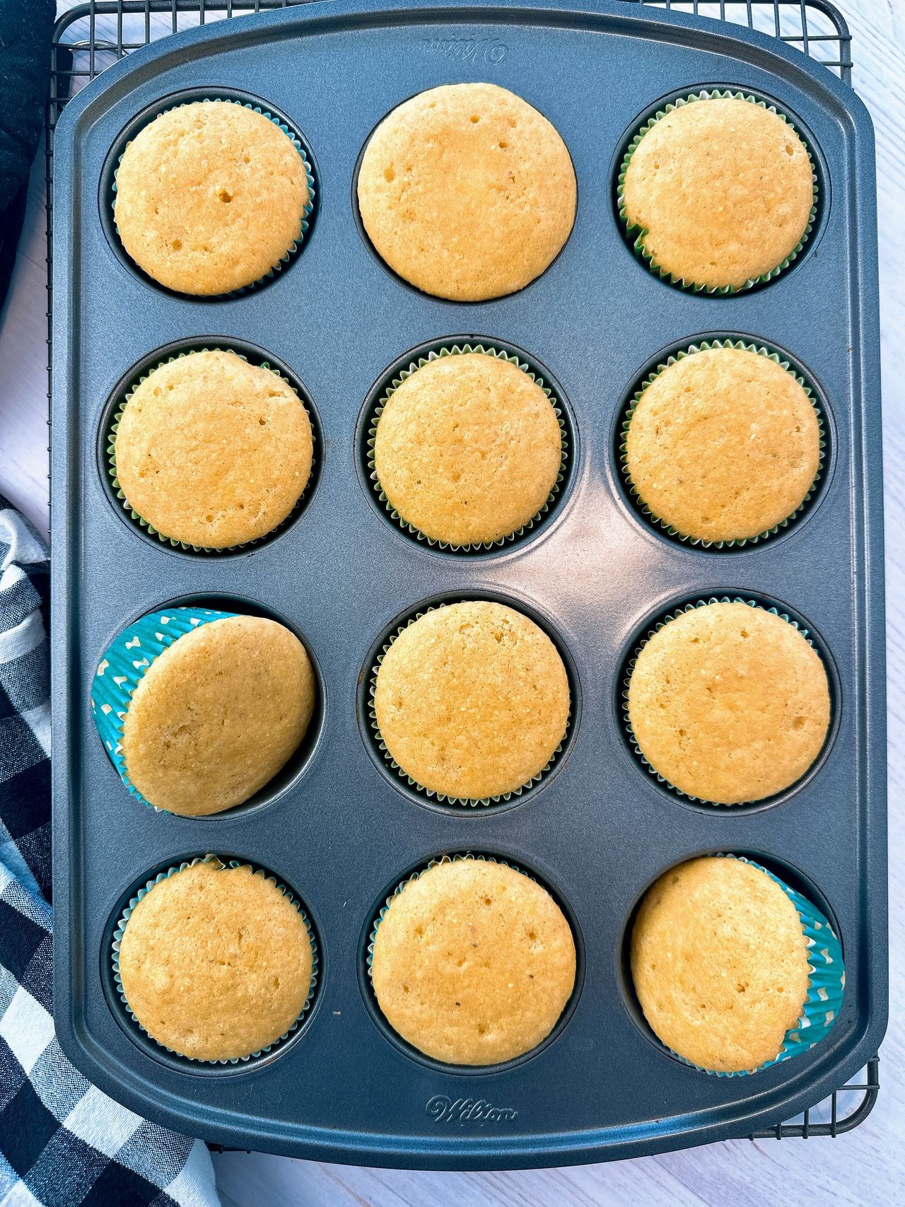 cornbread muffins on a wire rack and white counter