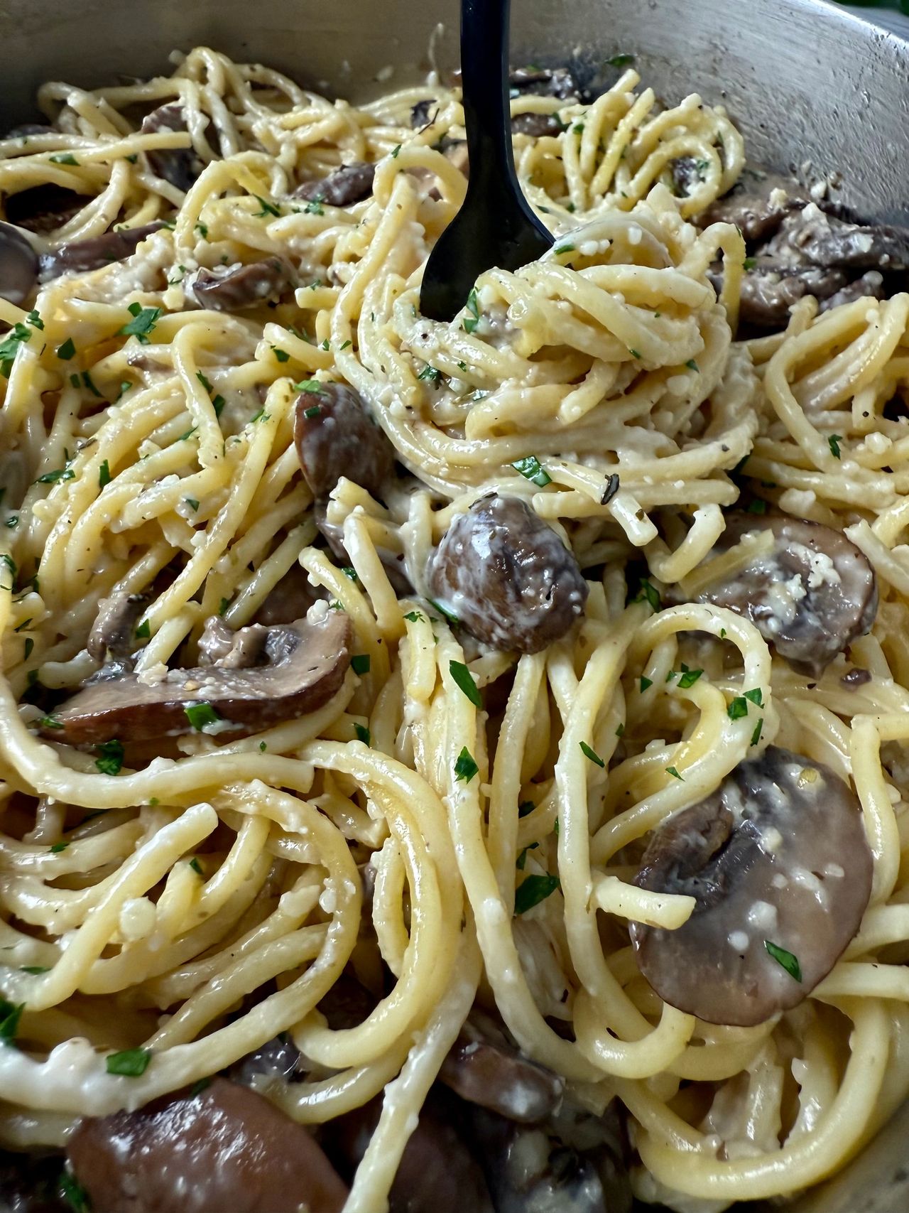 Pasta with Mushrooms in a skillet with a black fork