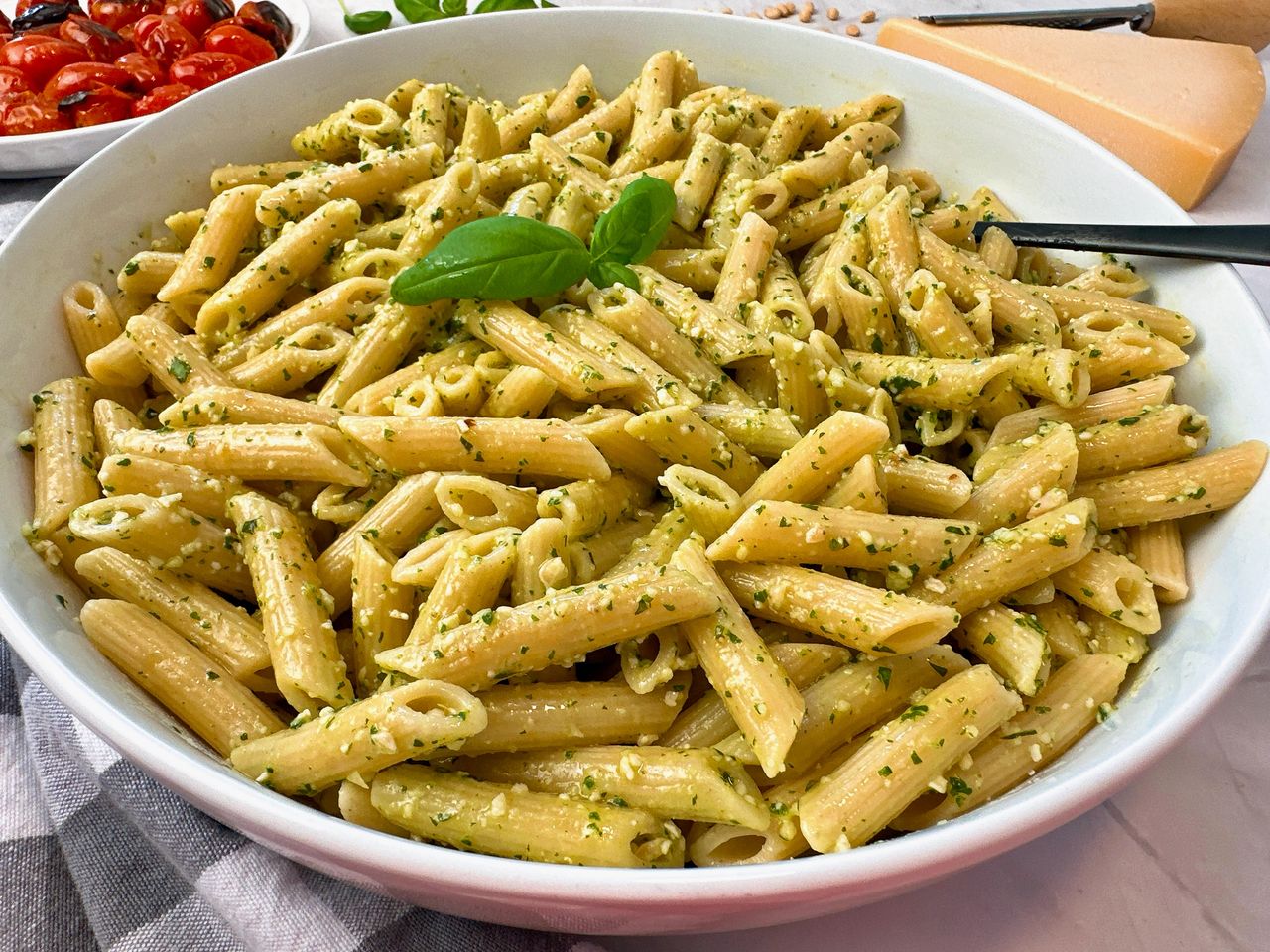 penne pasta with pesto and blistered tomatoes