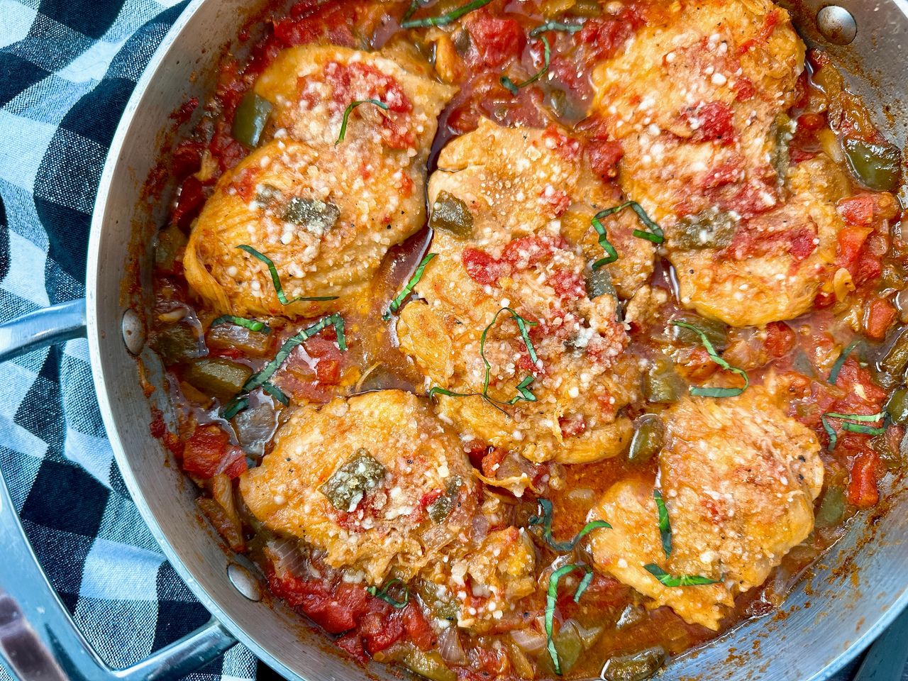 chicken thighs and vegetables in a skillet