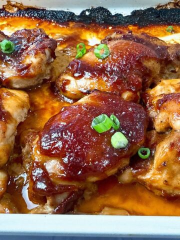 chicken thighs on a baking sheet with a teriyaki glaze