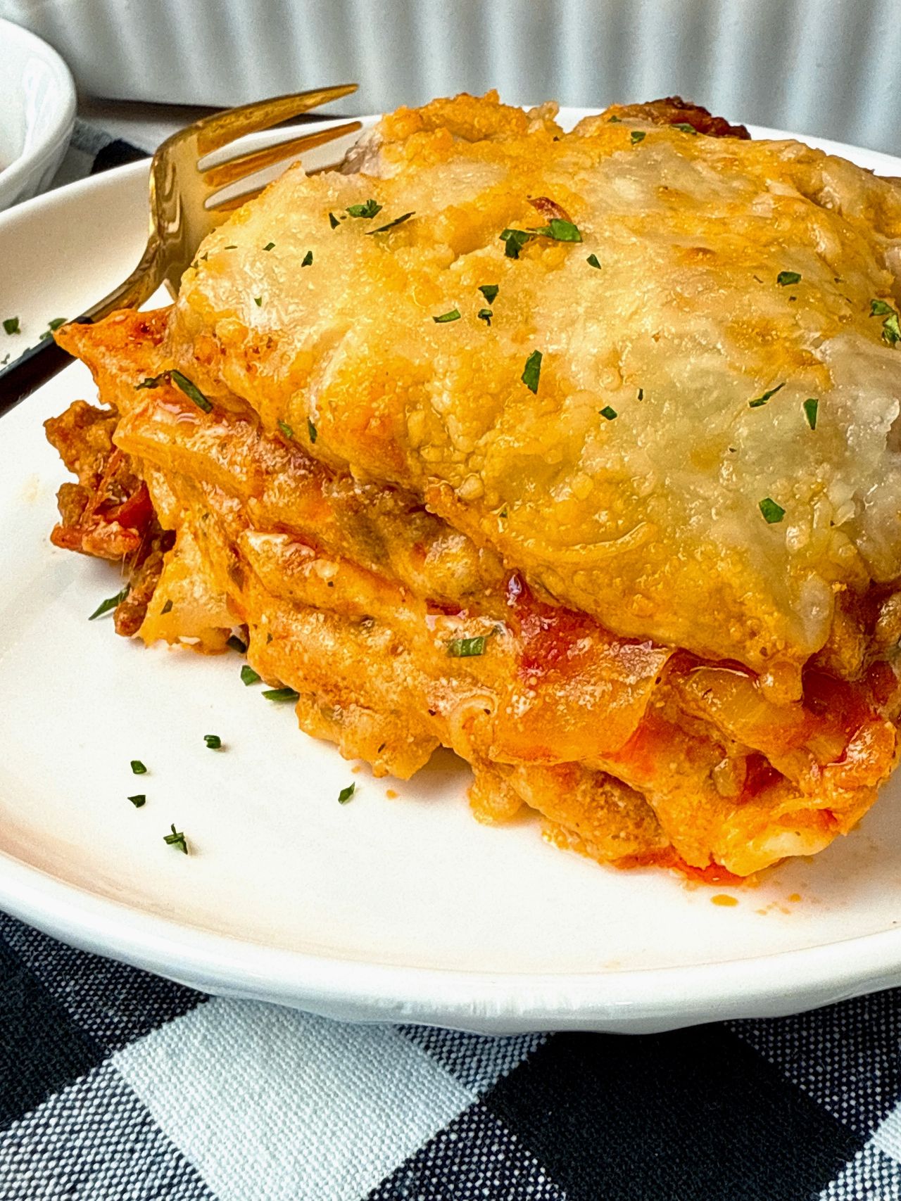 slice of lasagna on a white plate