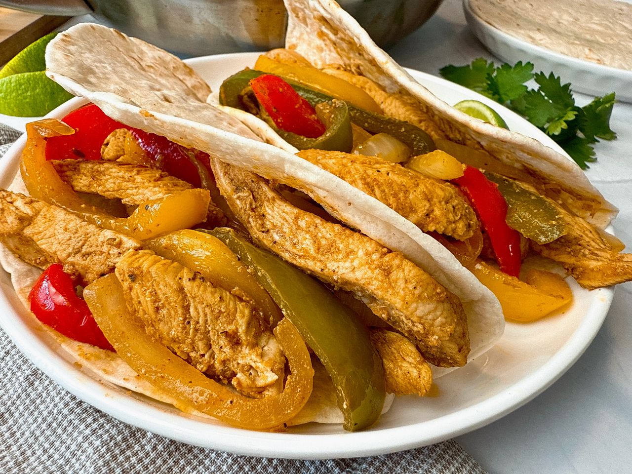 chicken and bell peppers in tortillas to make fajitas