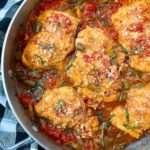 chicken thighs and vegetables in a skillet