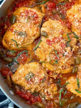 chicken thighs and vegetables in a skillet