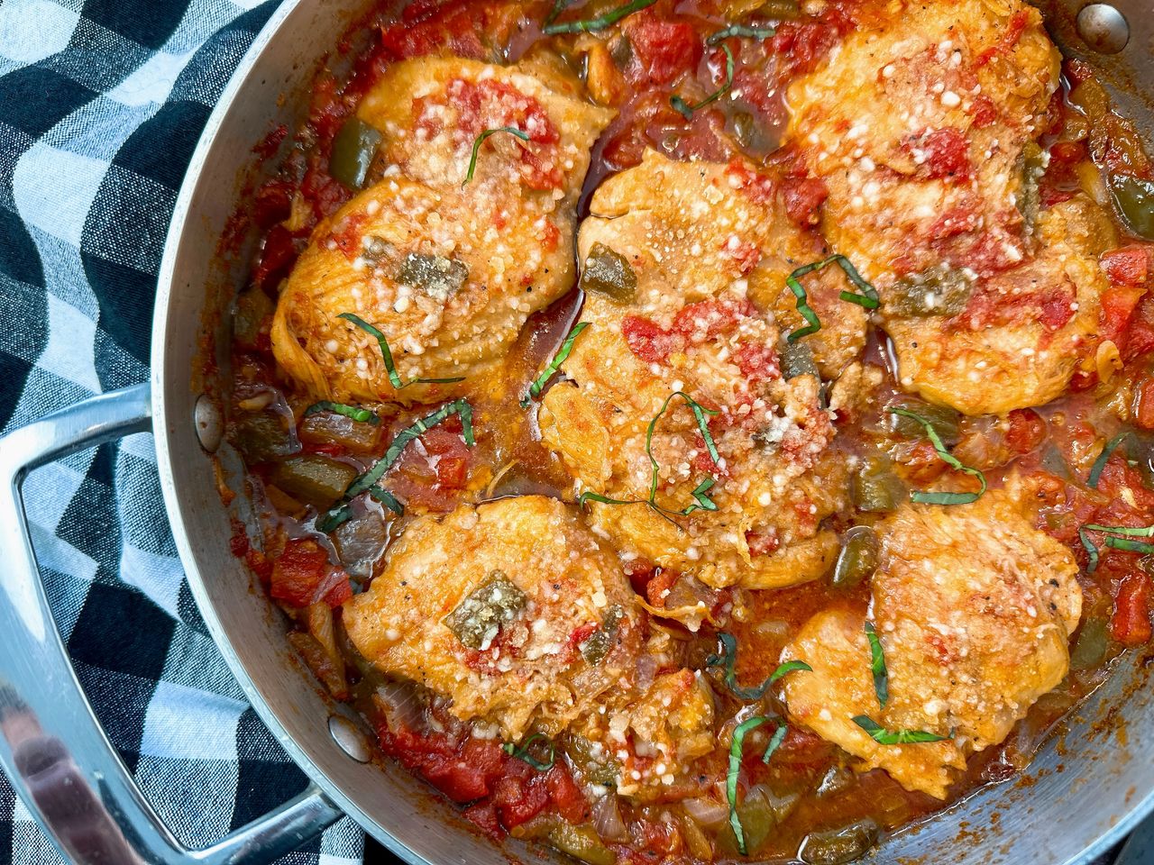 chicken thighs and vegetables in a skillet