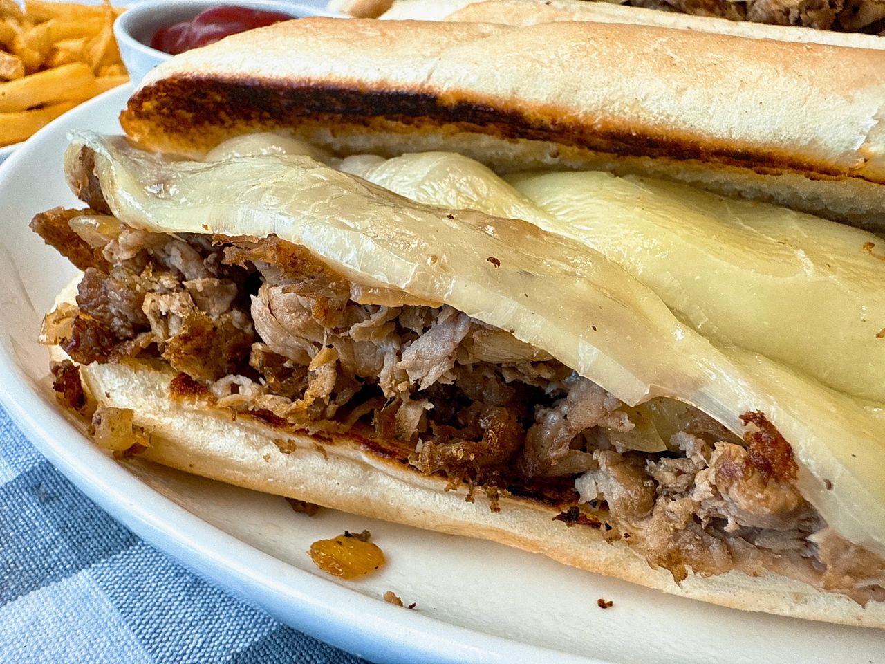 philly cheesesteak on a white plate