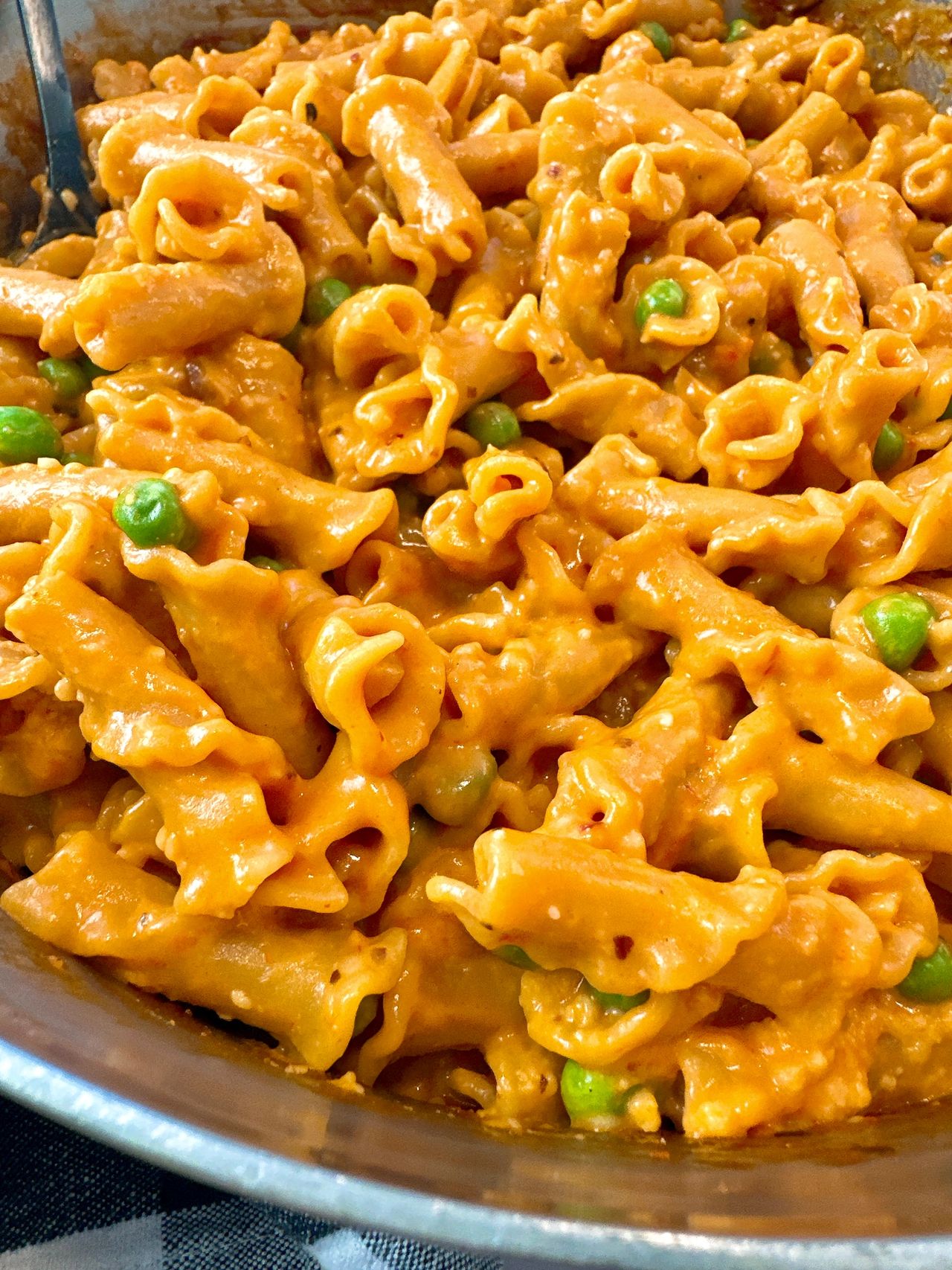 pasta and peas in a white bowl