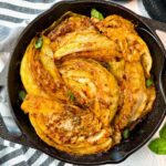 cabbage and marinara sauce in a cast iron skillet