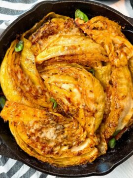 cabbage and marinara sauce in a cast iron skillet
