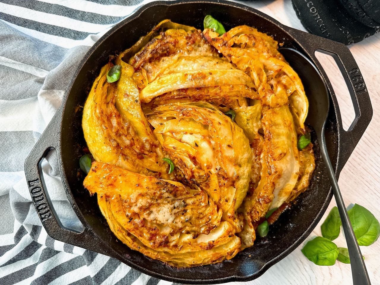 cabbage and marinara sauce in a cast iron skillet