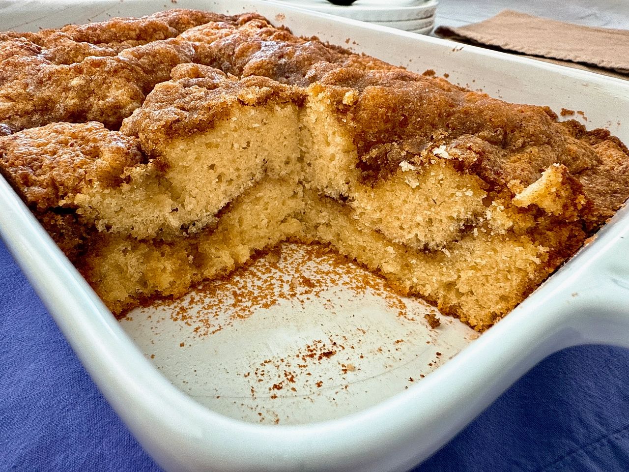 coffee cake in a white baking dish with two slices removed