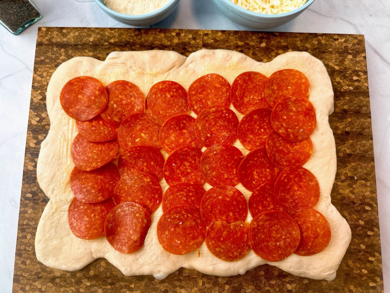 bread dough with pepperoni slices