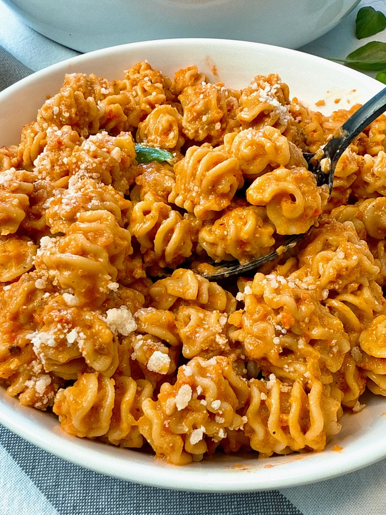 radiatori pasta with roasted red pepper sauce in a white bowl