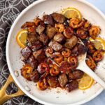 steak and shrimp in a white skillet