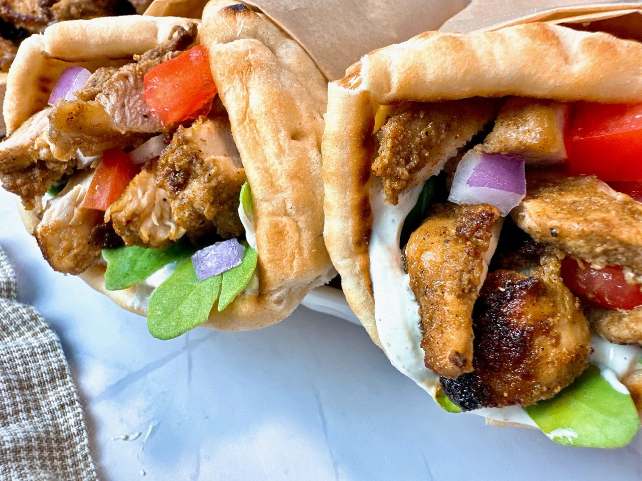 chicken shawarma wraps on a white plate