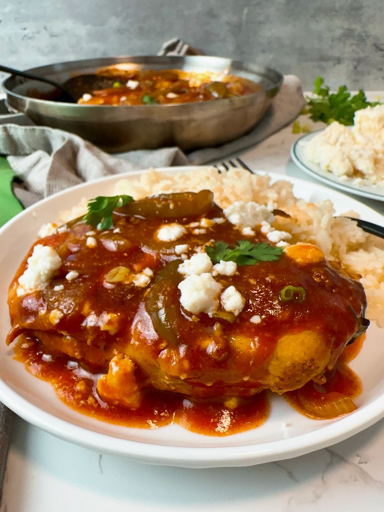 taco chicken and peppers in a skillet and on a plate