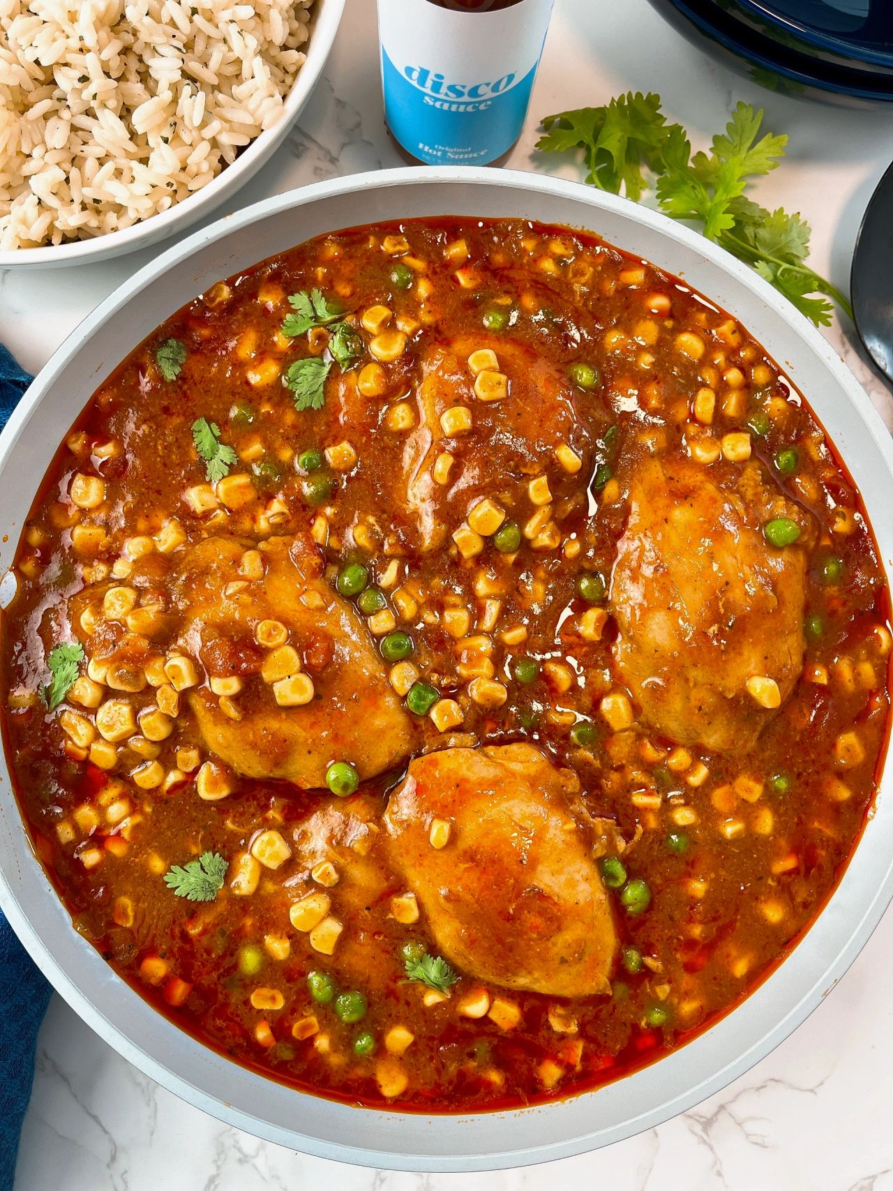 enchilada chicken thighs with corn and peas