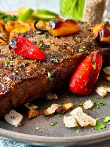 steak with roasted peppers and onions