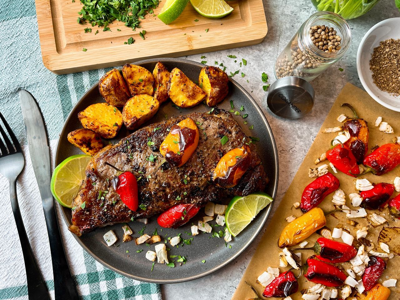 steak with roasted peppers and onions