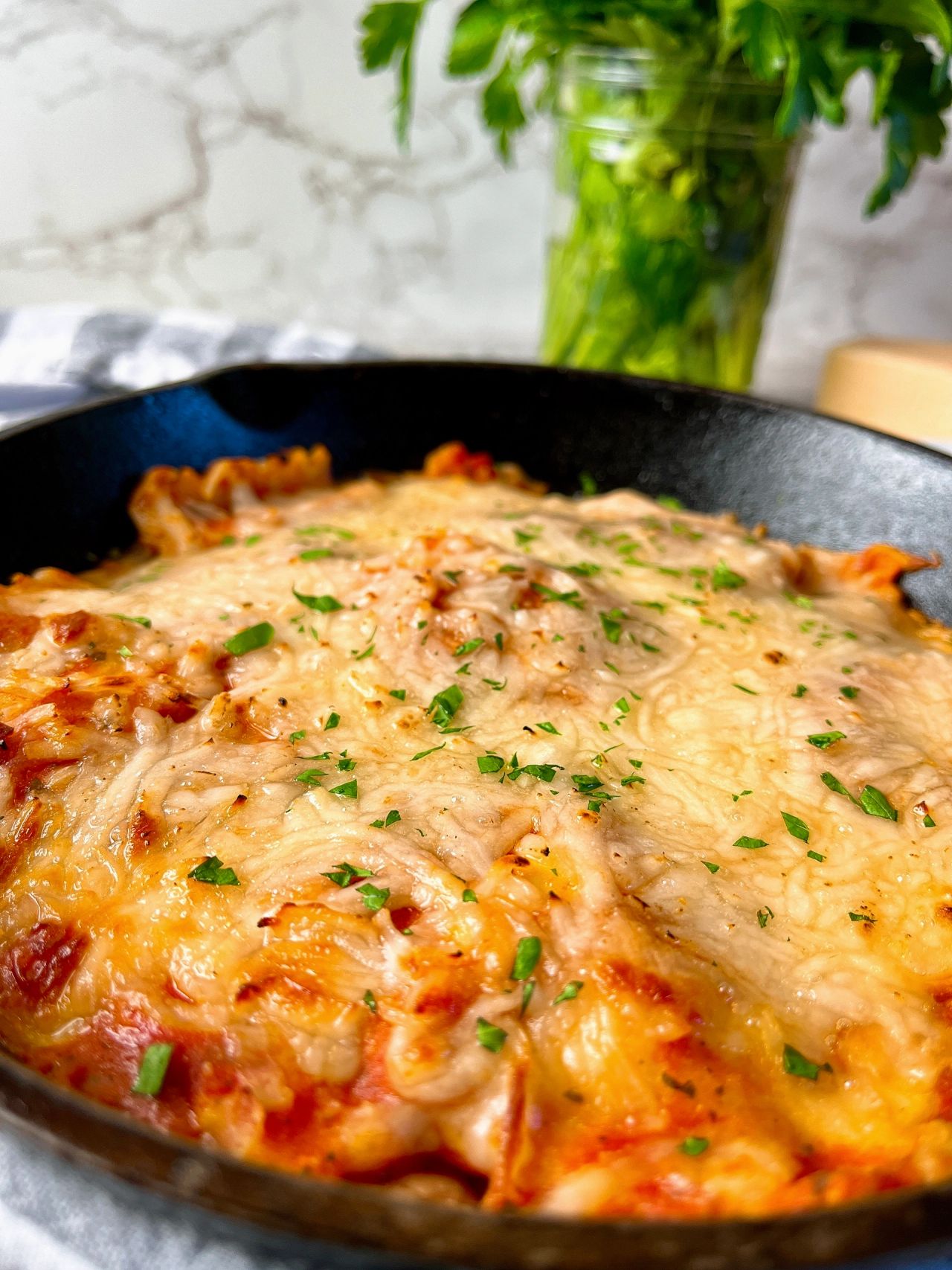ravioli in a skillet covered with cheese