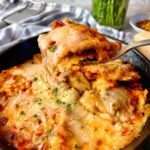 ravioli in a skillet covered with cheese