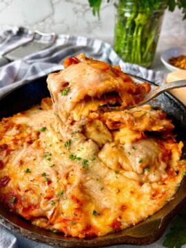 ravioli in a skillet covered with cheese
